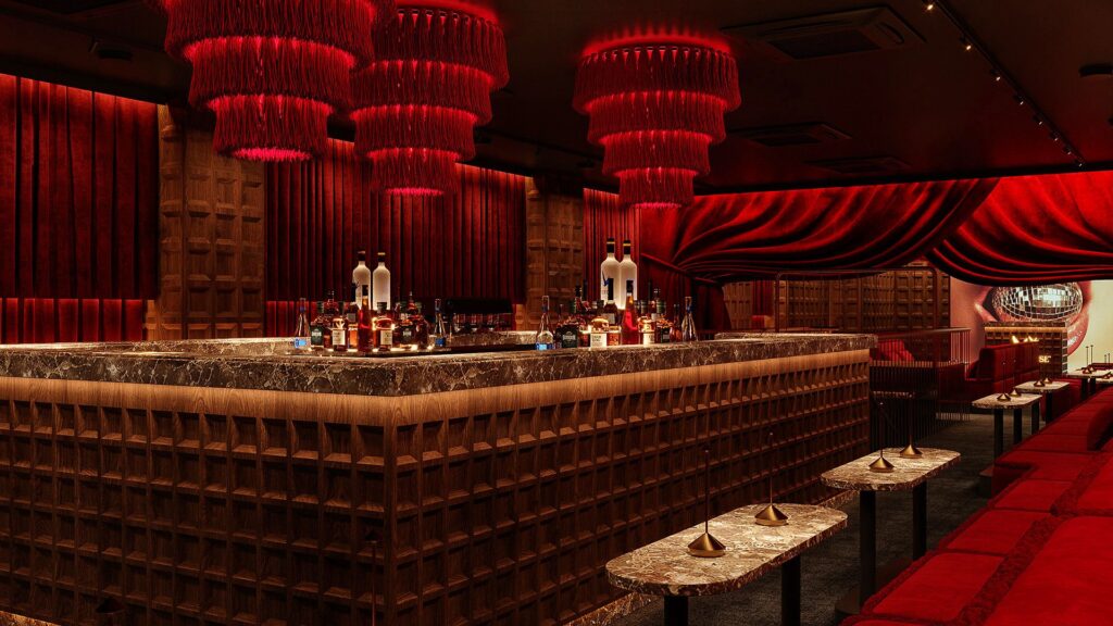 Marble bar counter under red fringe chandeliers